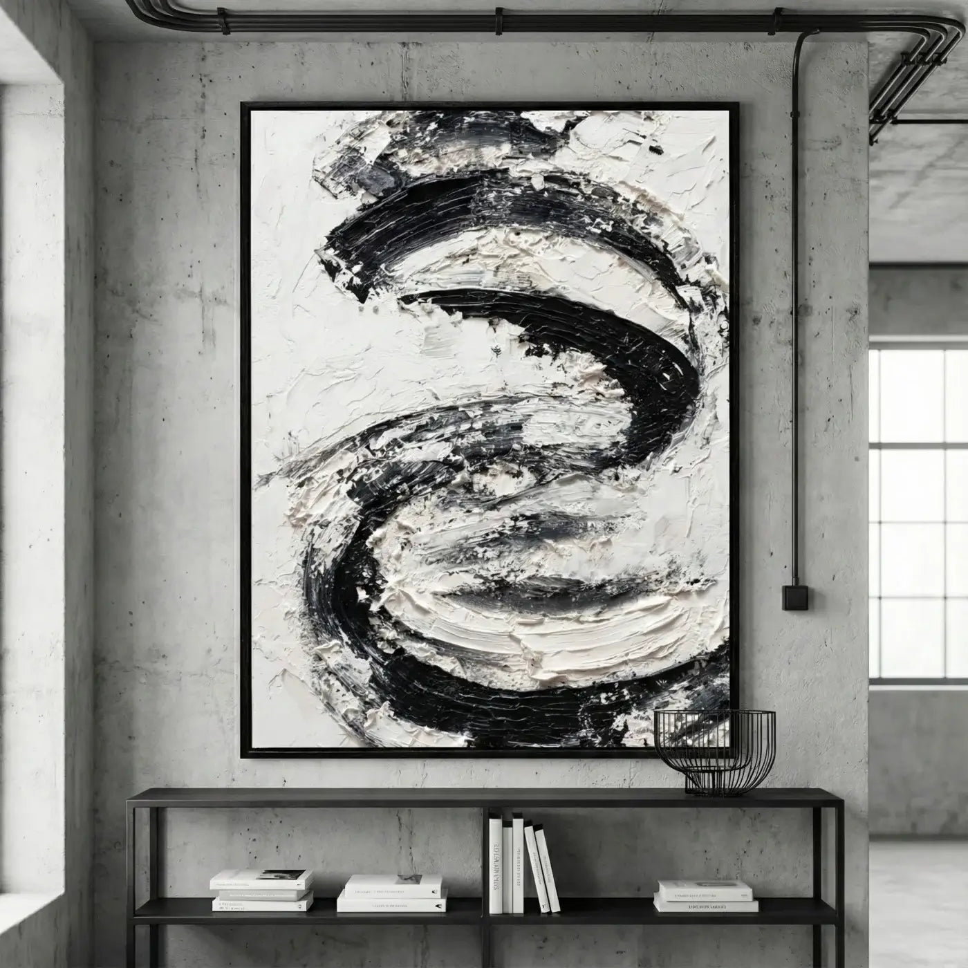 Abstract black and white painting on a wall in a modern interior setting.