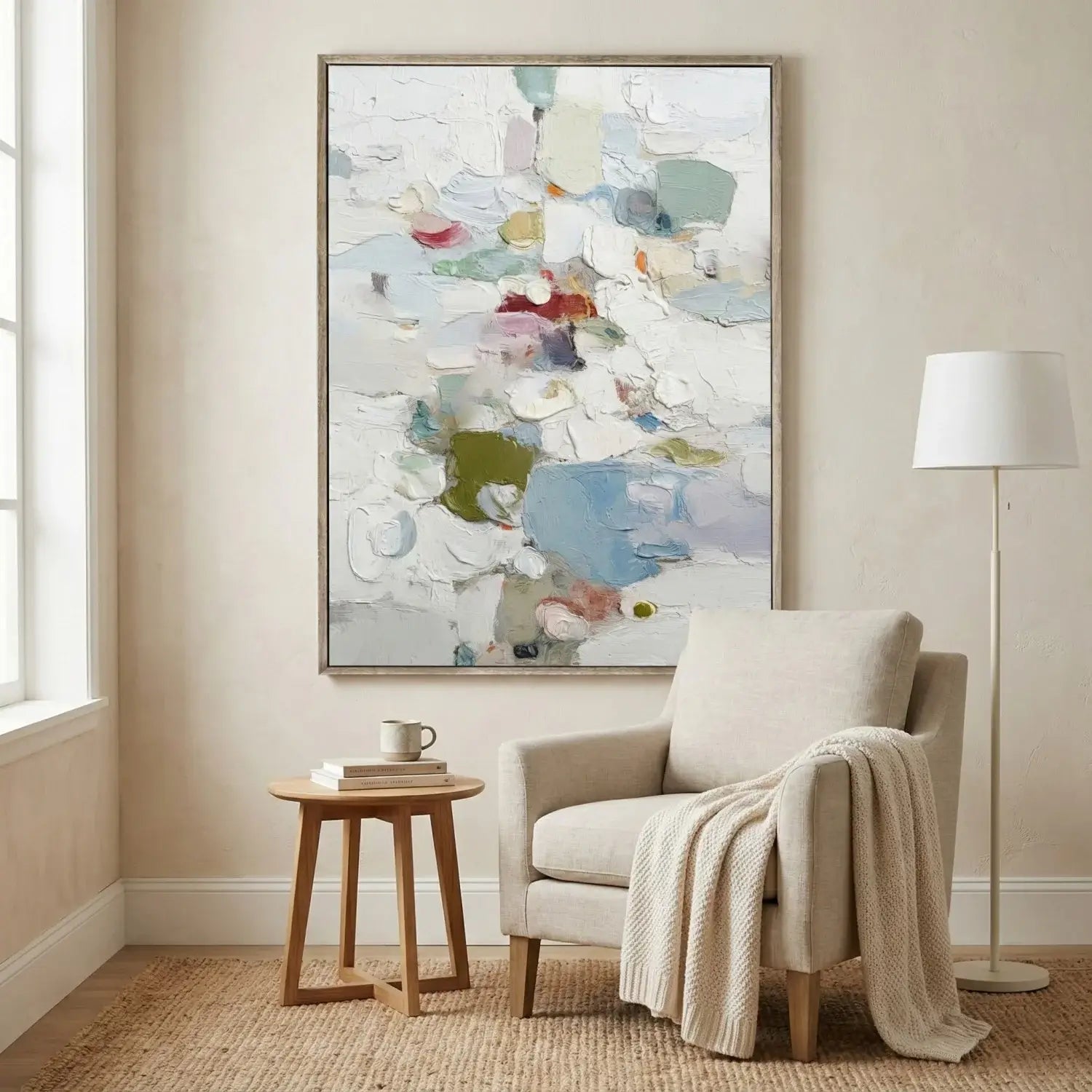 Living room with a beige armchair, small wooden table, and abstract painting on the wall.