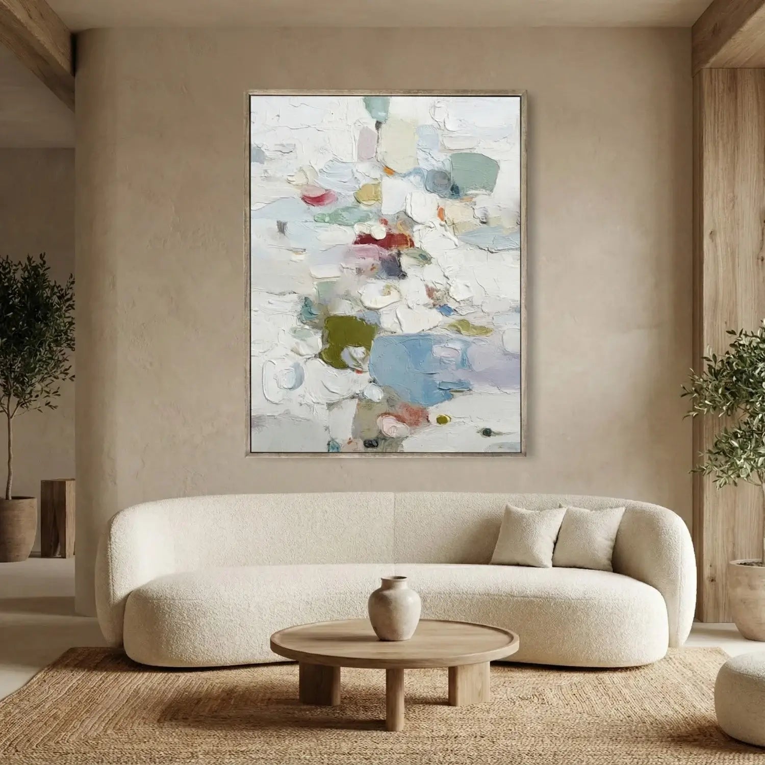 Modern living room with a beige sofa, round coffee table, and abstract art on the wall.