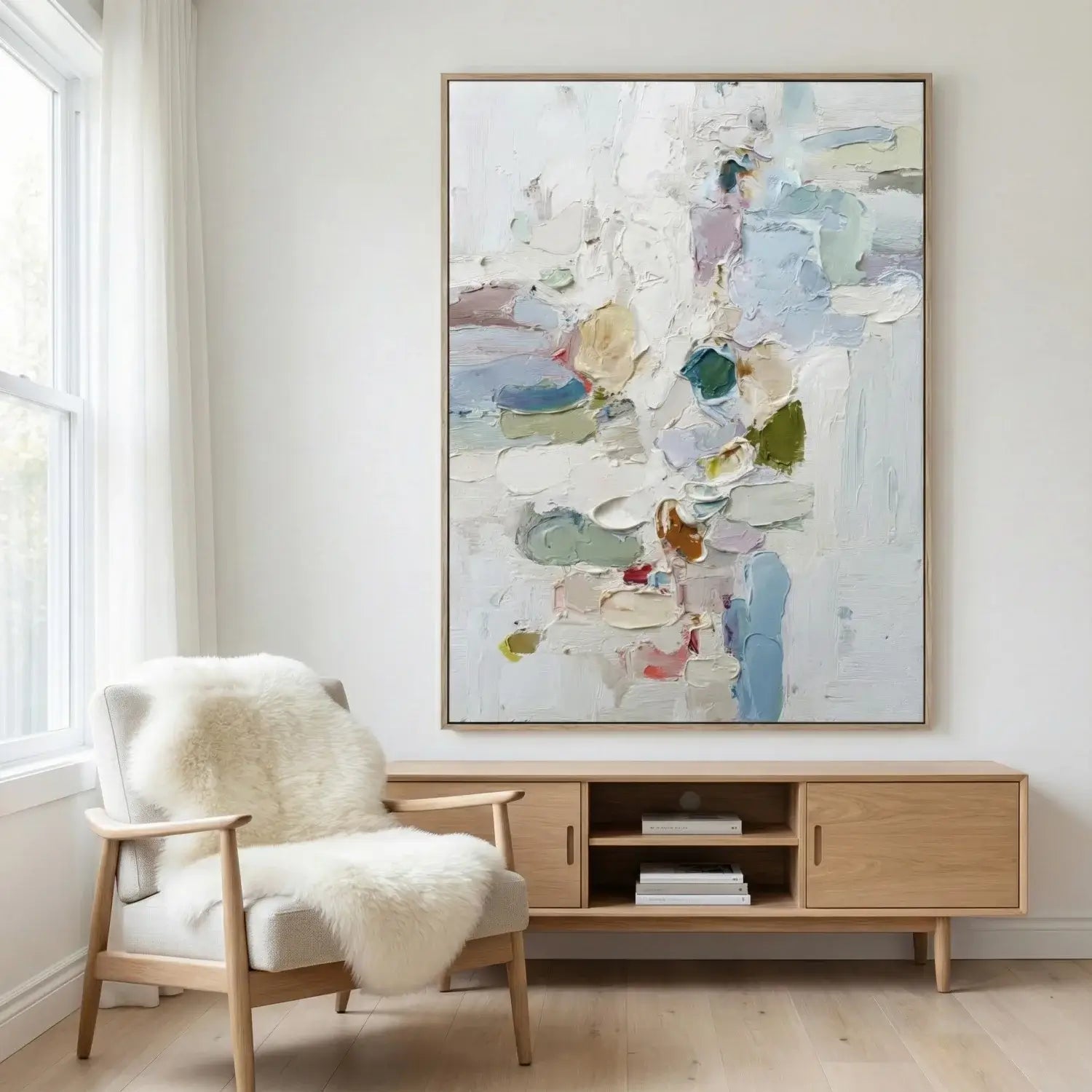 Modern living room with abstract art, chair, and wooden cabinet.