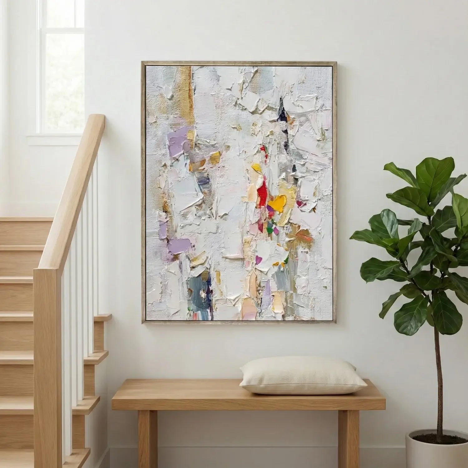Abstract painting on a wall above a wooden bench with a plant to the side.