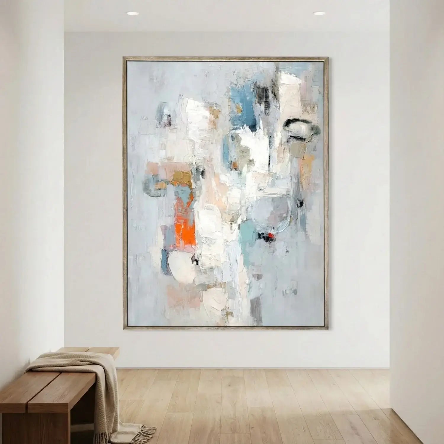 Abstract painting in a modern interior setting with a wooden bench and light-colored floor.