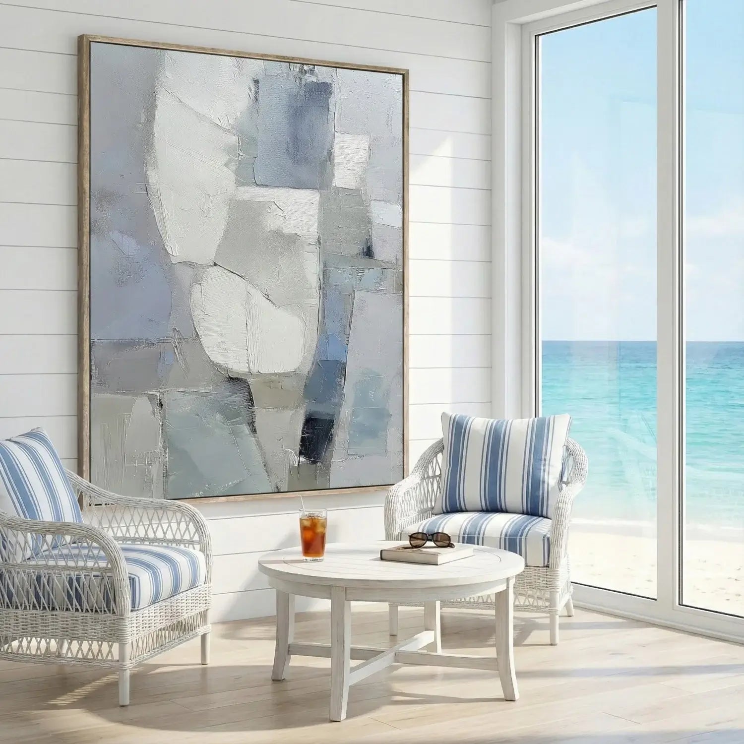 Living room with wicker chairs, a coffee table, and a large abstract painting.