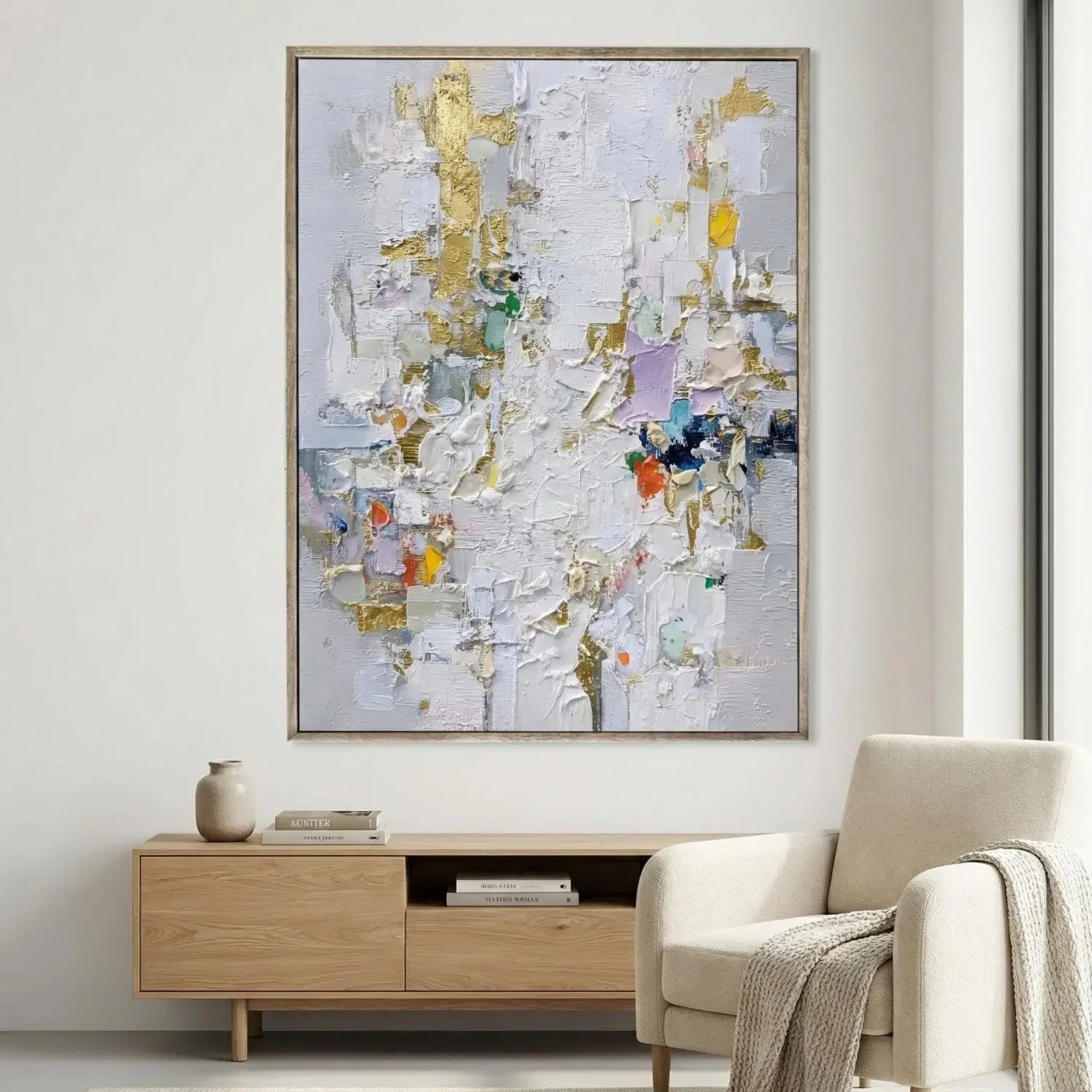 Abstract painting on a wall above a wooden console table in a living room.