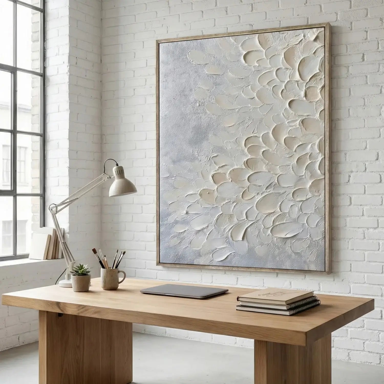 Modern office setup with wooden desk, lamp, and abstract wall art.