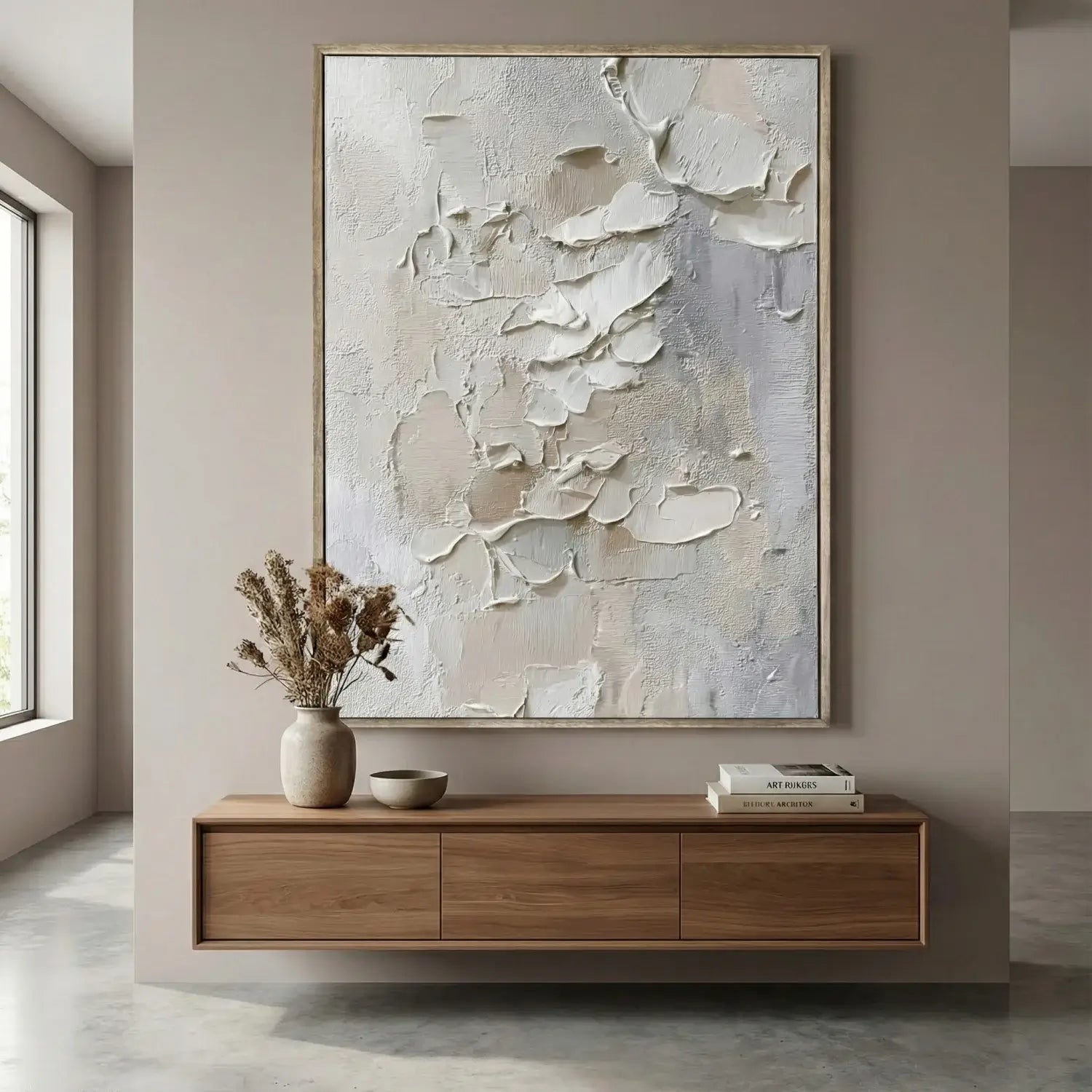 Abstract painting on a wall above a wooden console table with decor items.