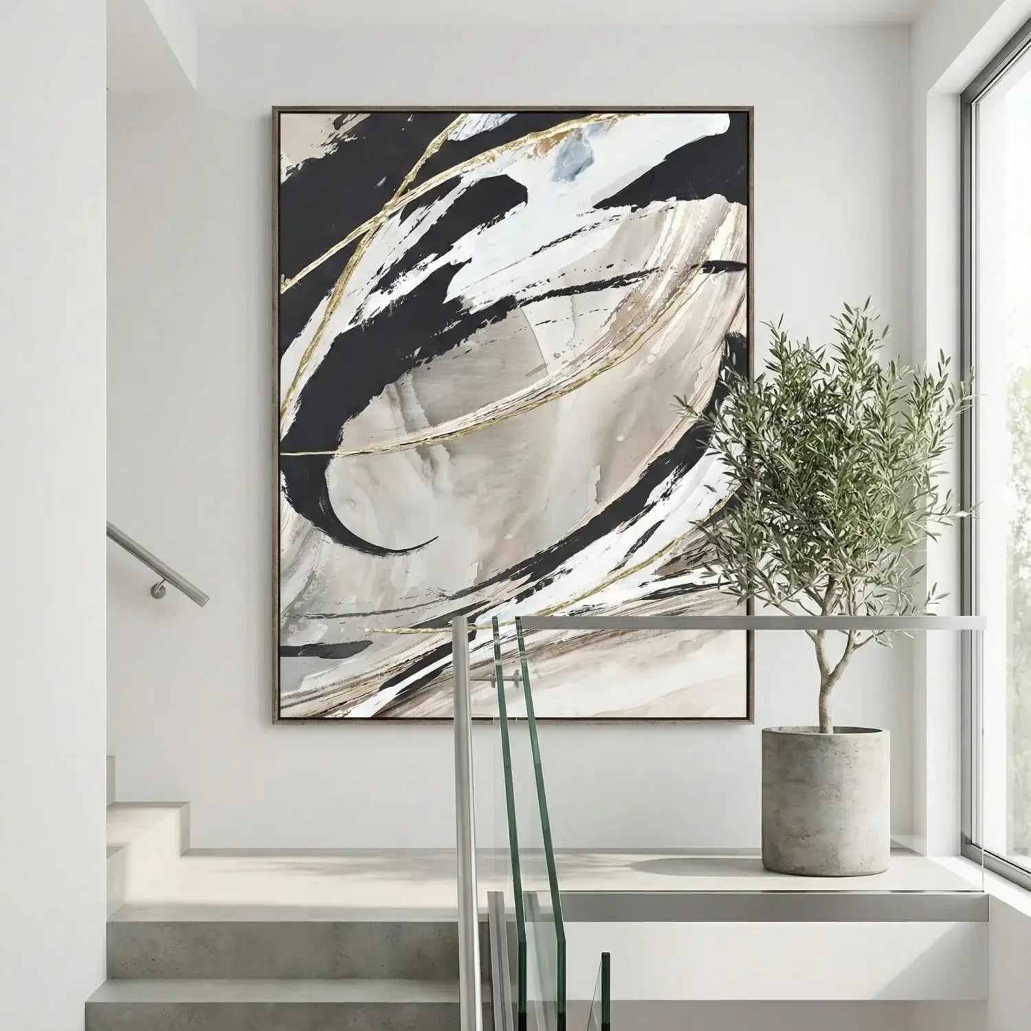 Abstract art piece on a wall in a modern interior setting with a plant and staircase.