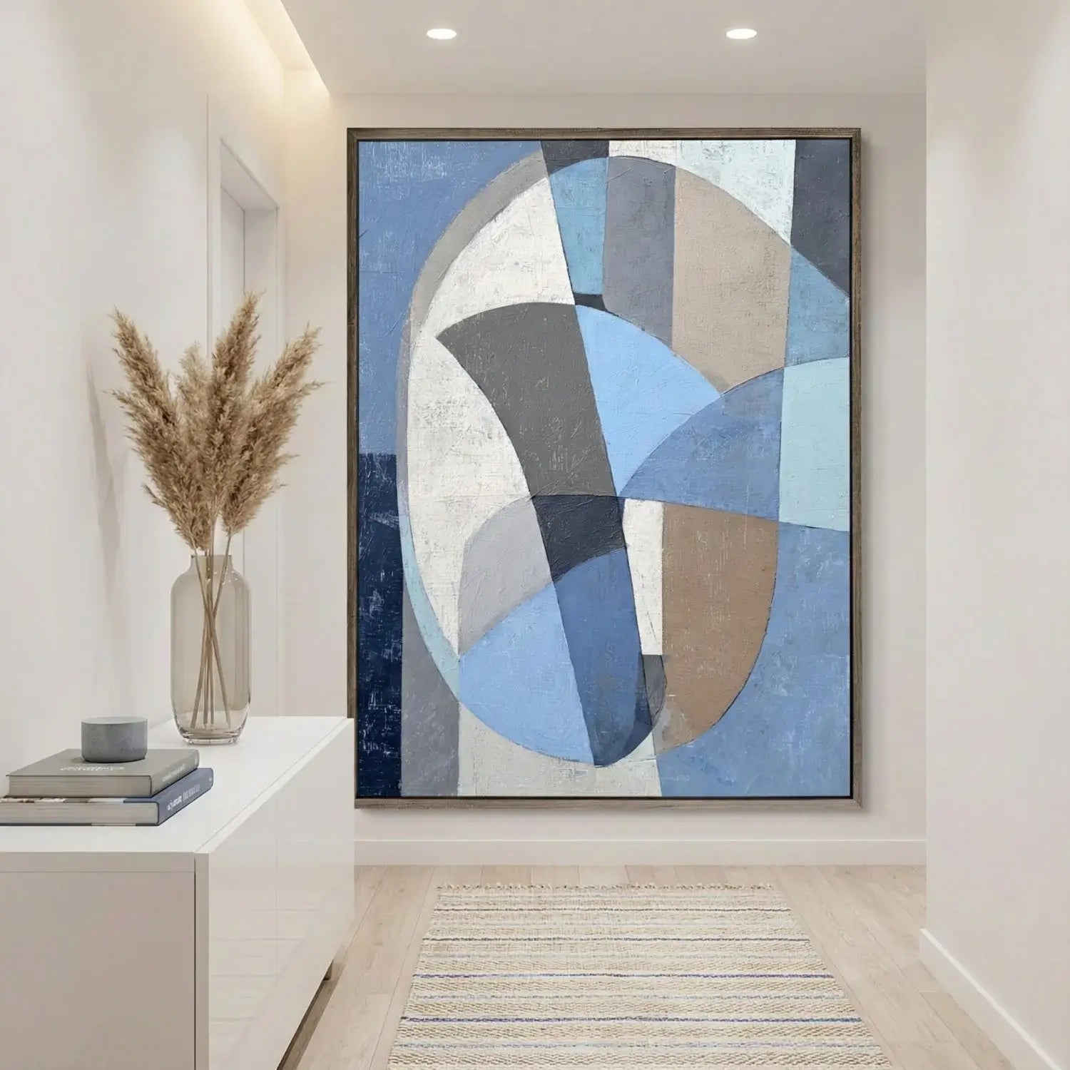 Abstract art piece in a modern interior setting with a vase and decor items.