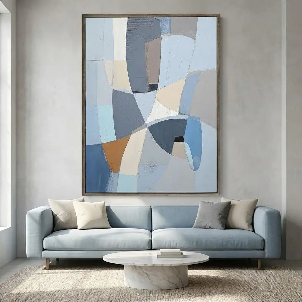 Modern living room with a light blue sofa, abstract art, and marble coffee table.