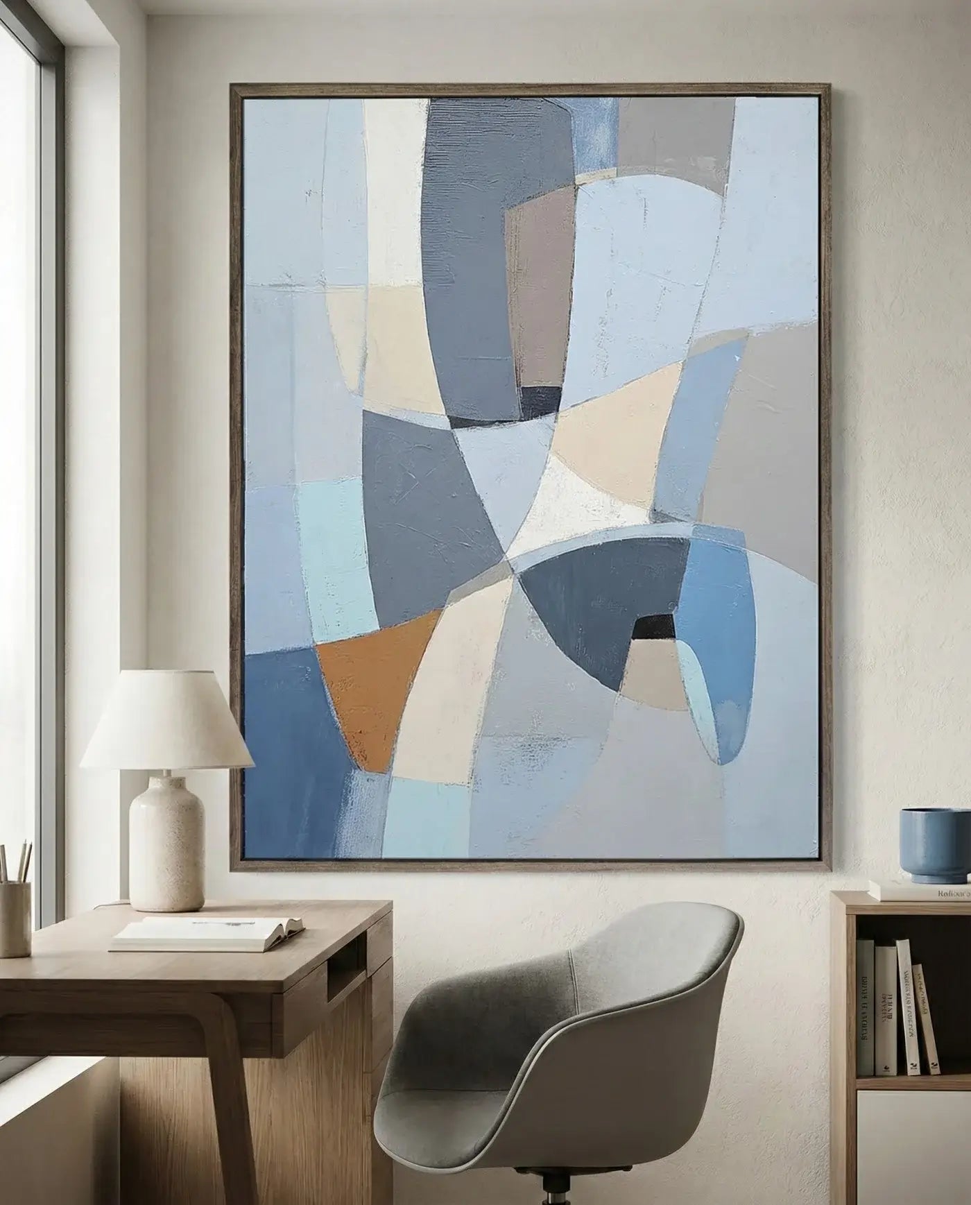 Abstract art piece on a wall above a desk in a home office setting