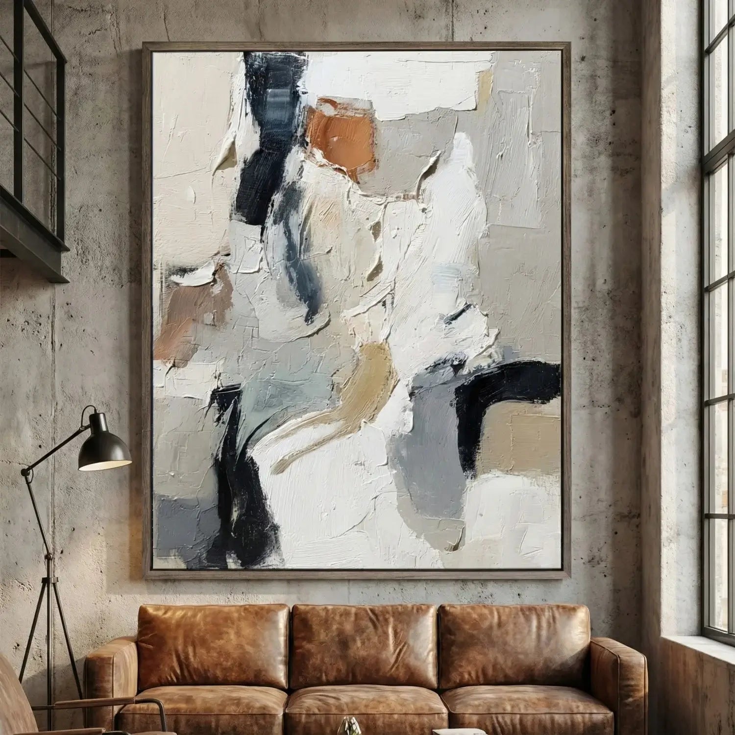 Abstract painting on a wall above a brown leather sofa in a modern interior setting.
