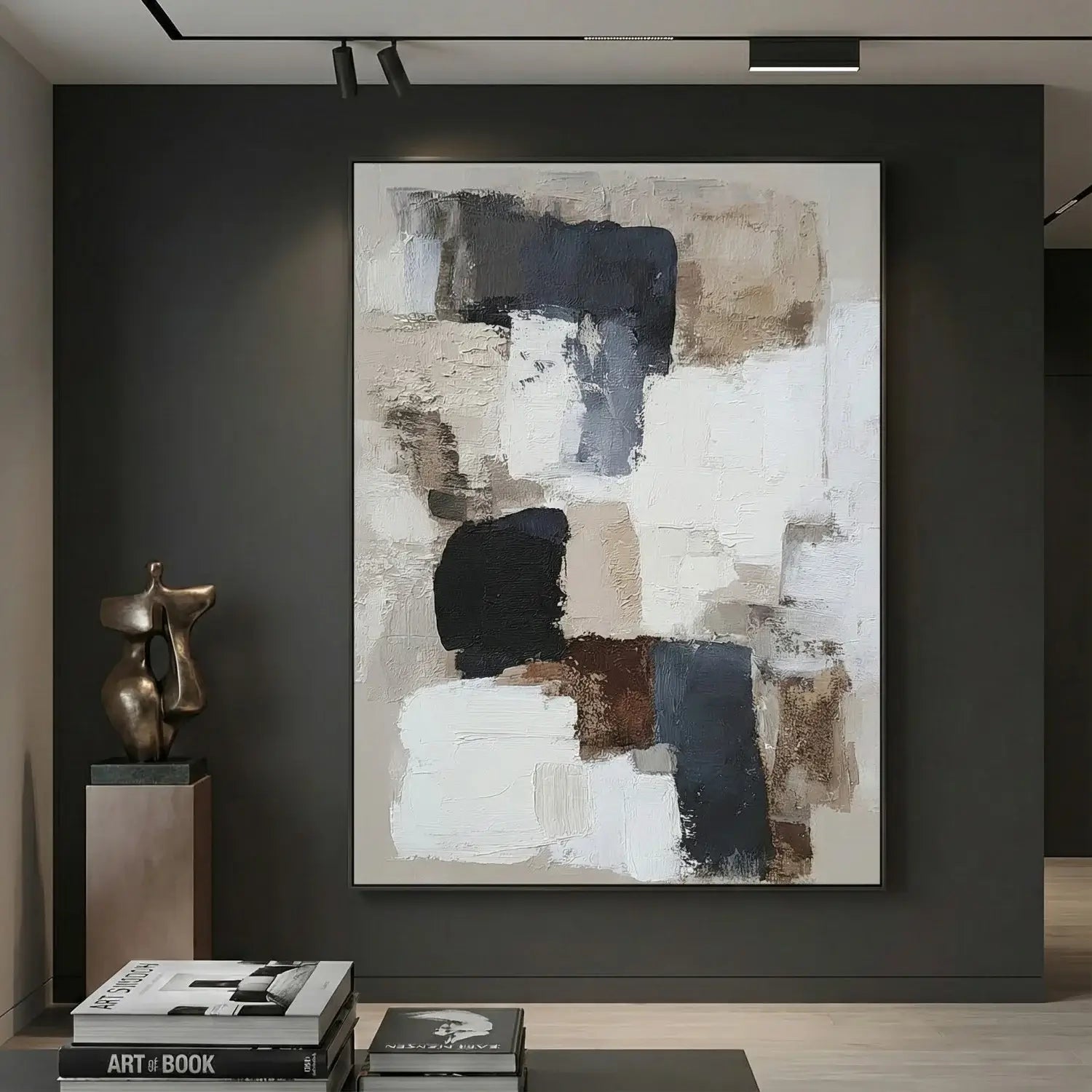 Abstract painting on a dark wall with books and a sculpture below