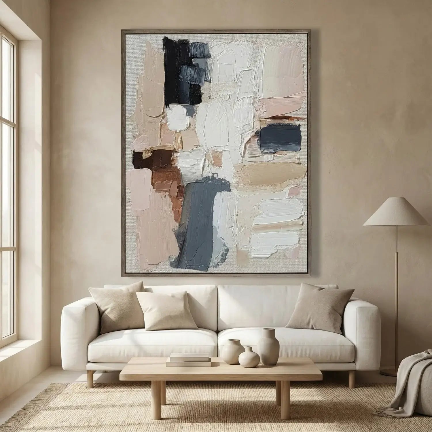 Modern living room with a white sofa, wooden coffee table, and abstract art on the wall.