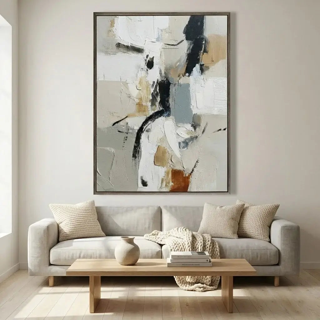 Living room with a gray sofa, wooden coffee table, and abstract art on the wall.