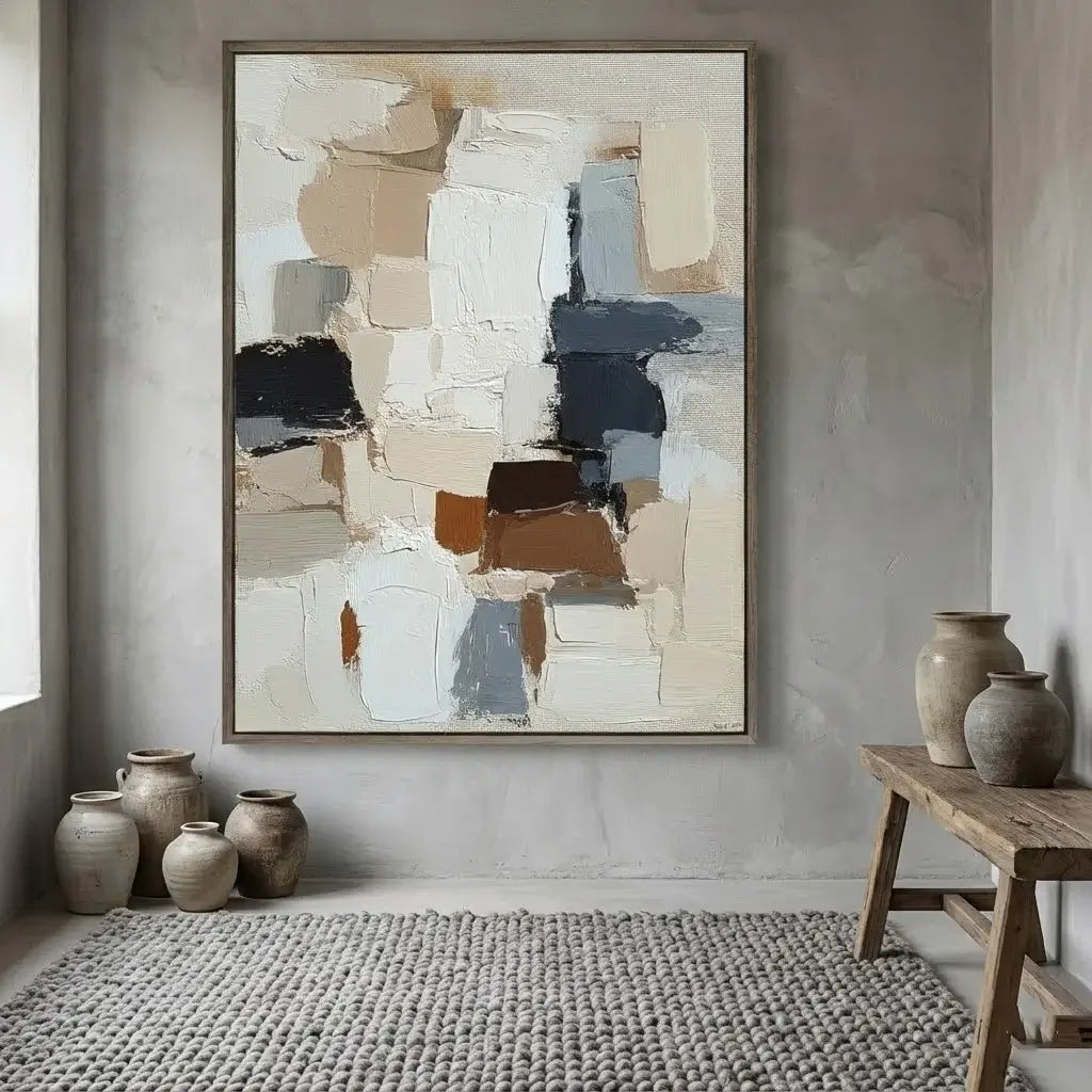 Abstract art piece on a wall with decorative vases and a wooden stool in a room.