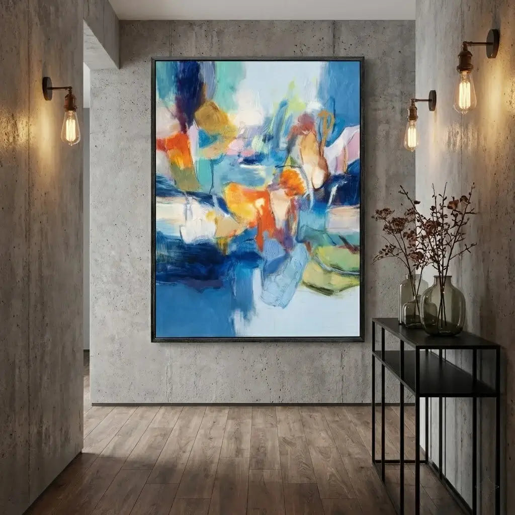 Colorful abstract painting on a wall in a modern interior setting with a console table and decorative items.