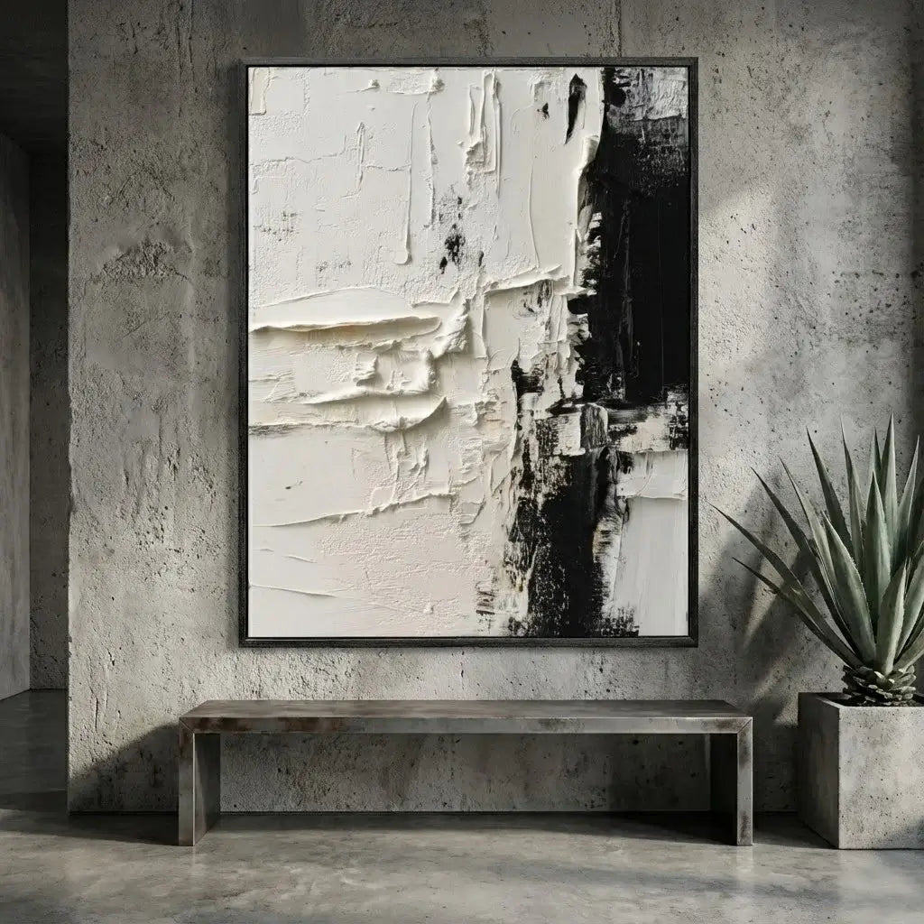 Abstract art piece on a concrete wall with a bench and plant