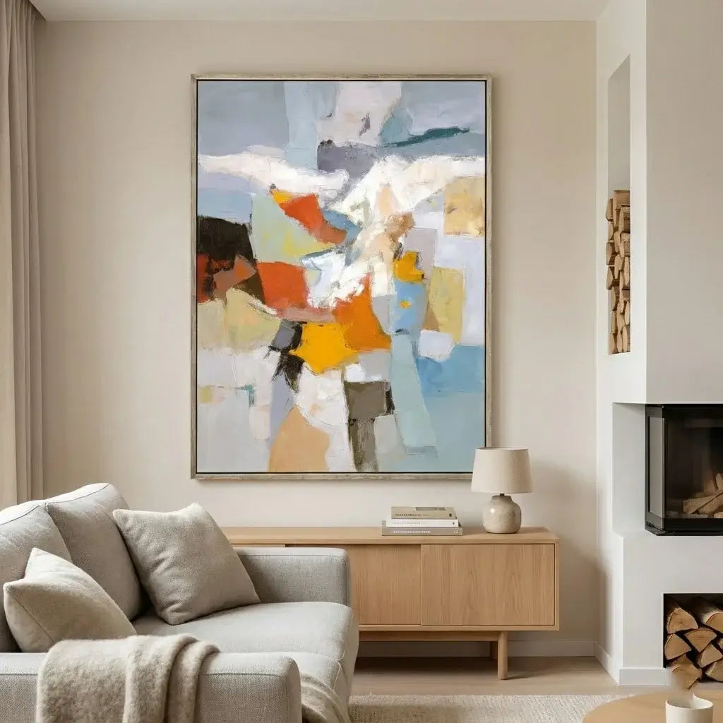 Modern living room with a colorful abstract painting on the wall, a gray sofa, and a wooden side table.