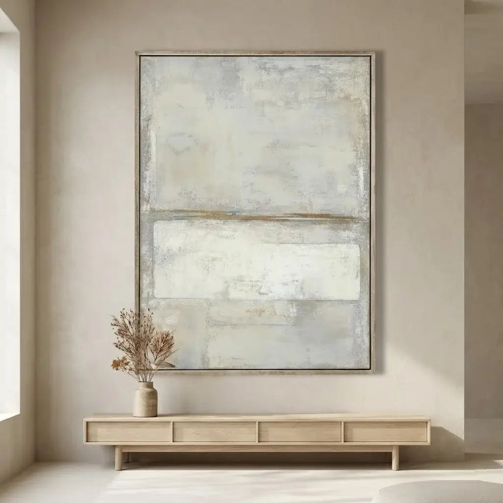 Abstract painting on a wall above a wooden console table with a vase.