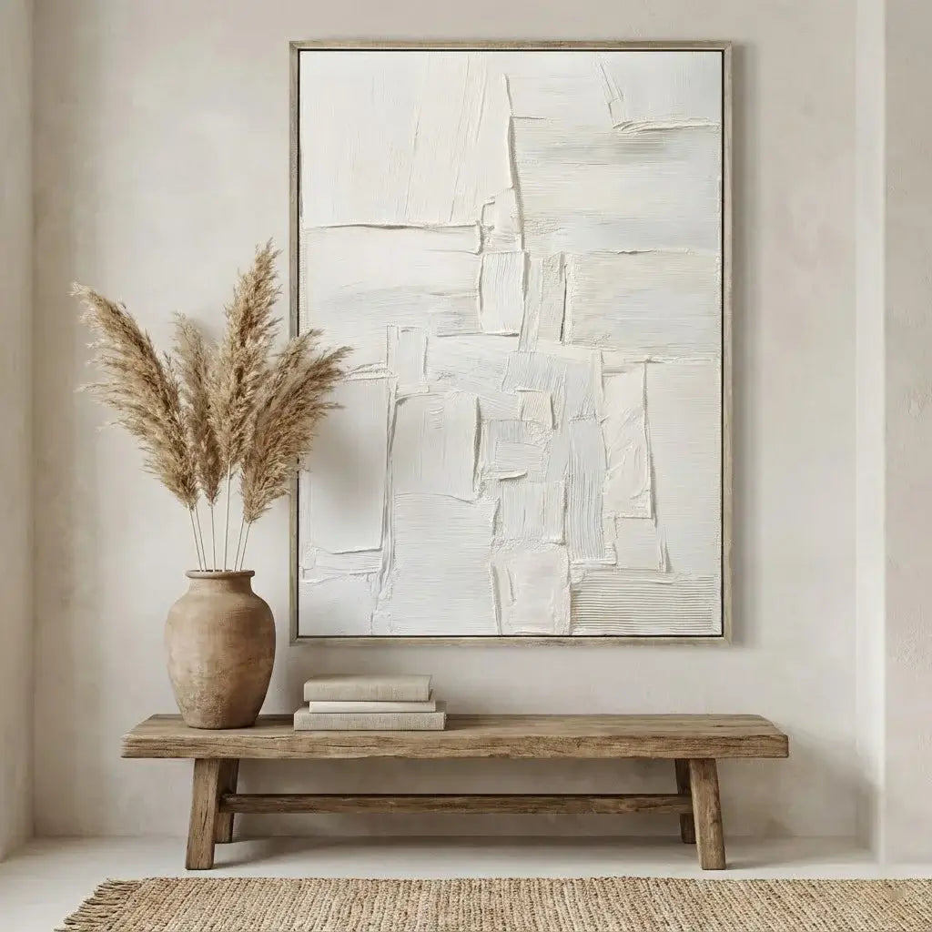 Abstract painting on a wall above a wooden bench with decorative items.