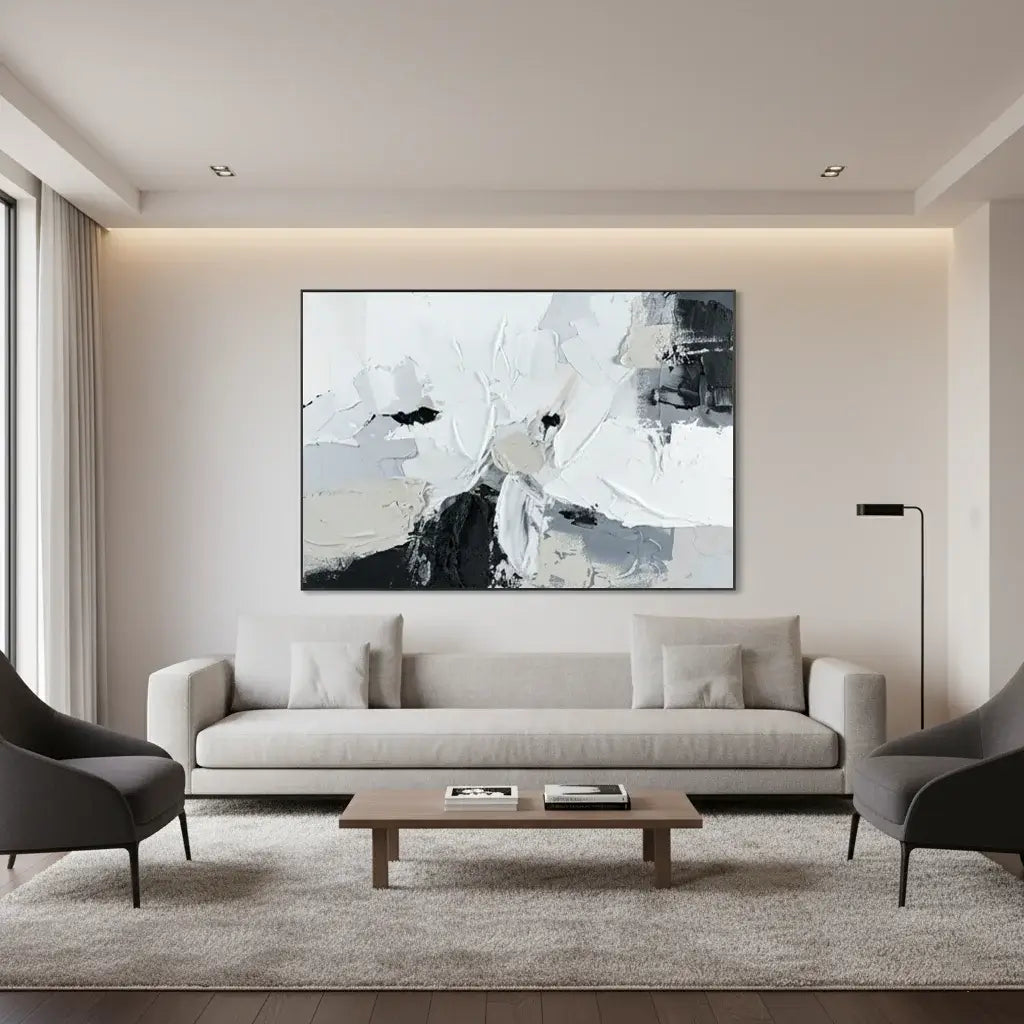 Modern living room with a white sofa, gray chairs, and a large abstract painting on the wall.