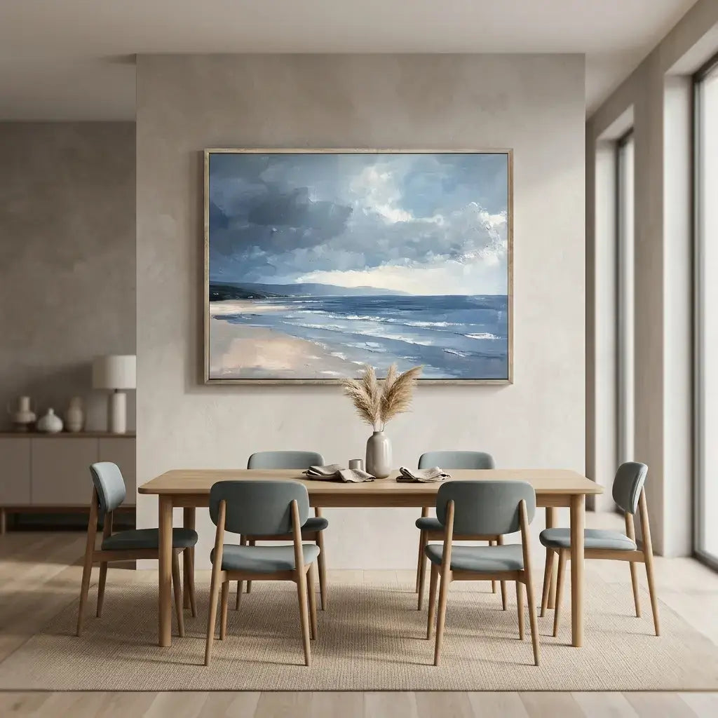 Dining room with a wooden table and chairs, featuring a large framed beach scene painting on the wall.