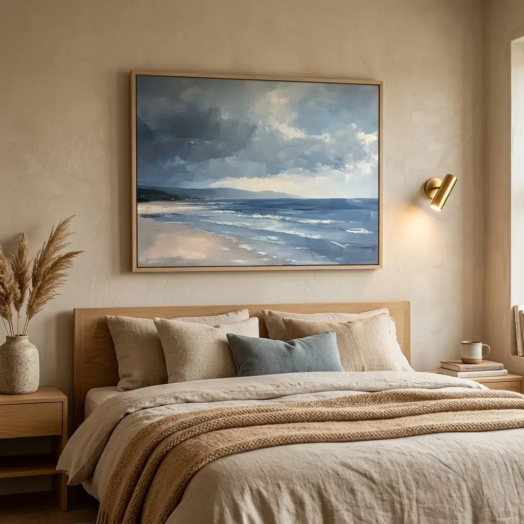 Bedroom with a large framed beach scene painting on the wall.