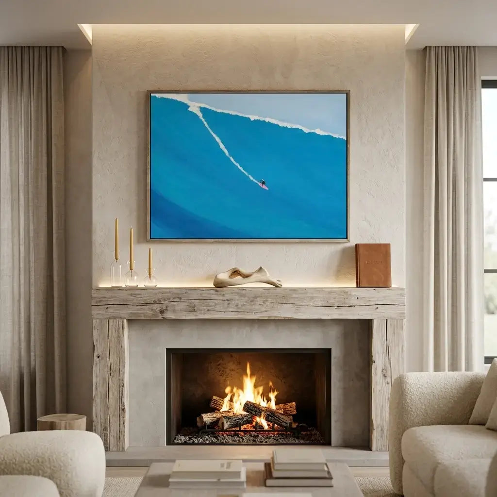 Living room with a fireplace, sofa, and wall art of a surfer in the ocean.