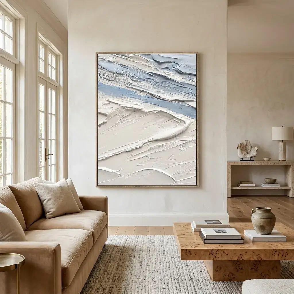 Modern living room with a beige sofa, wooden coffee table, and abstract art on the wall.
