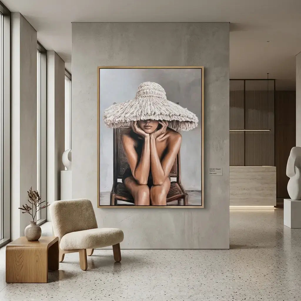 Framed artwork of a woman with a large hat in a modern interior setting.