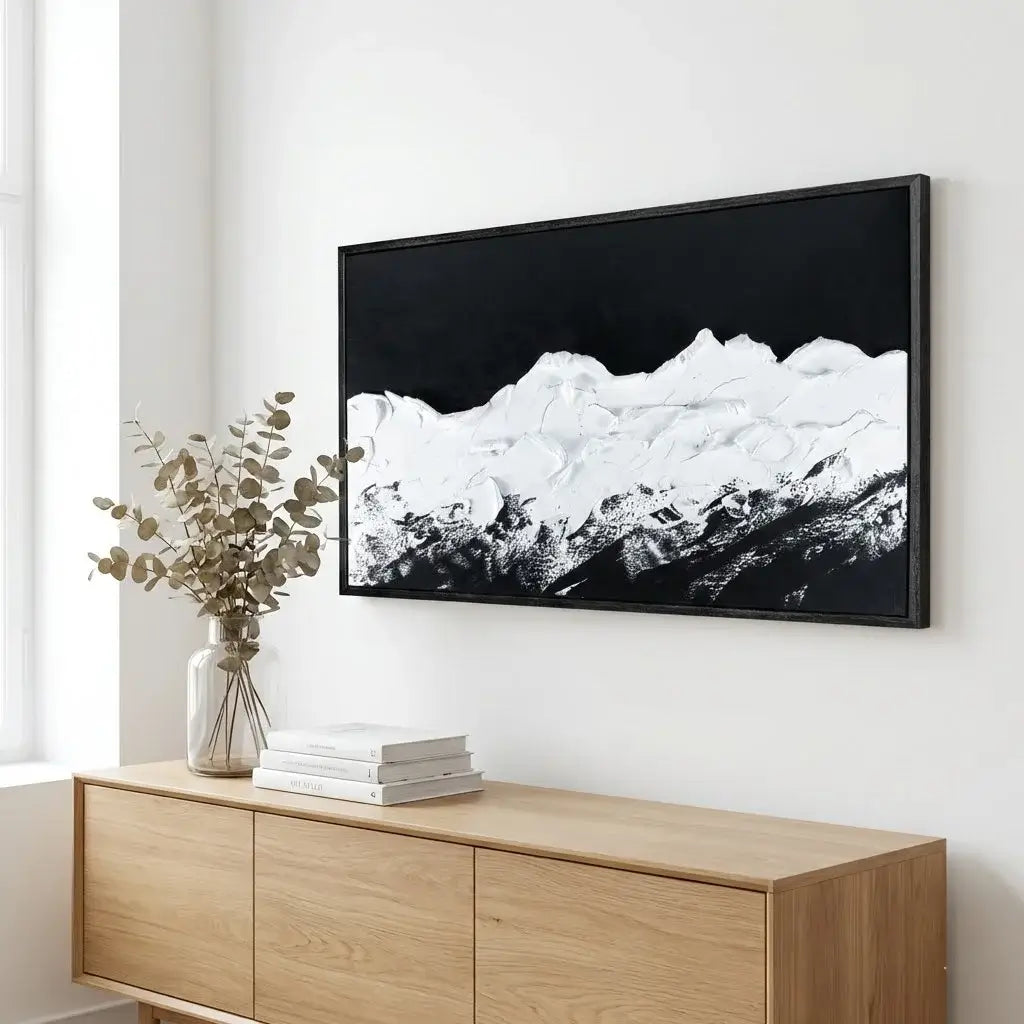 Modern living room with WALL ART, a wooden sideboard with books and a vase.