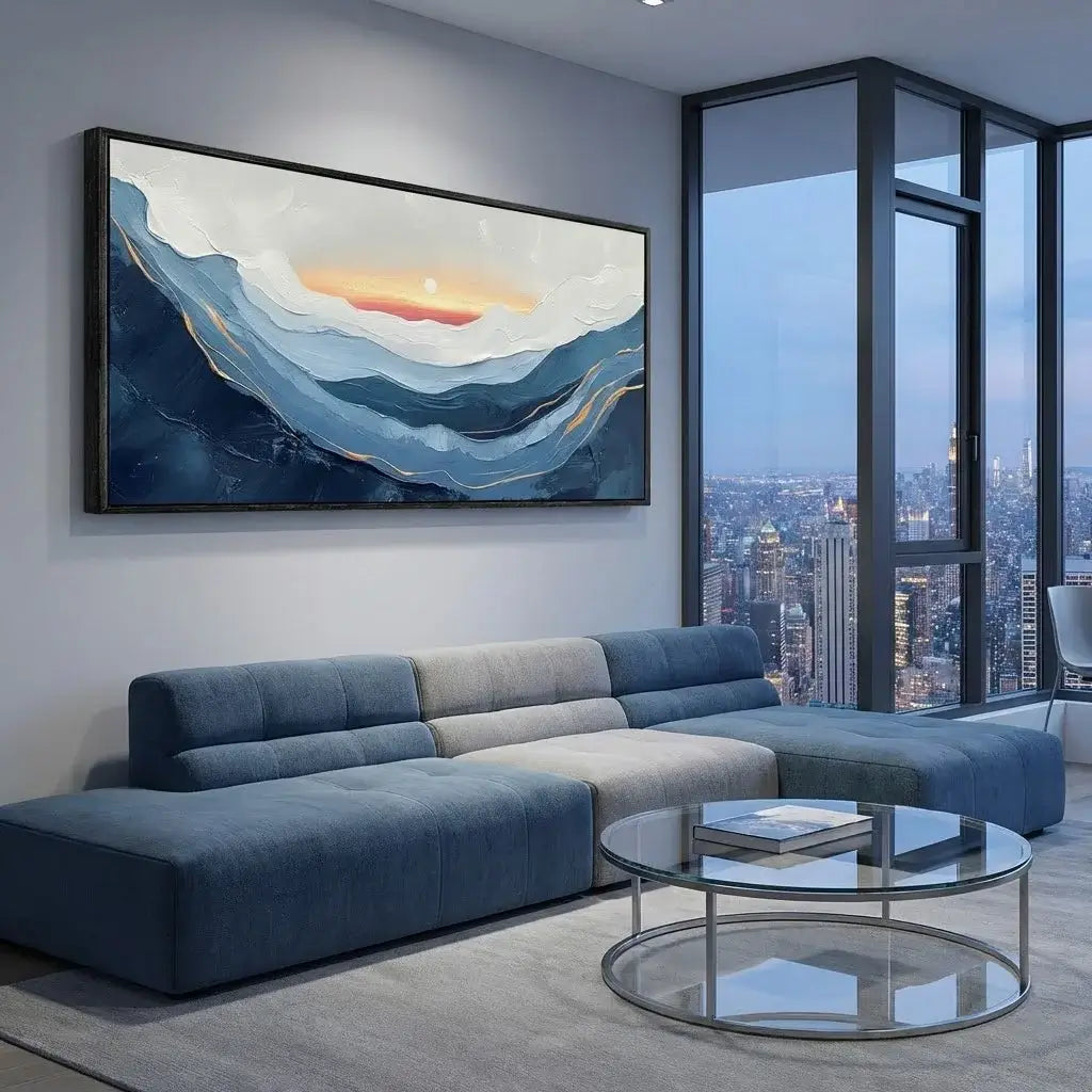 Modern living room with a blue sectional sofa, round glass coffee table, and abstract painting on the wall.