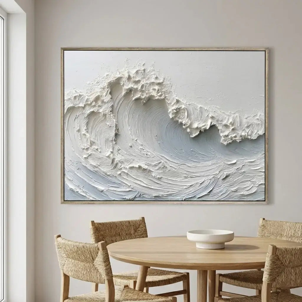 Framed abstract wave artwork above a dining table with chairs.