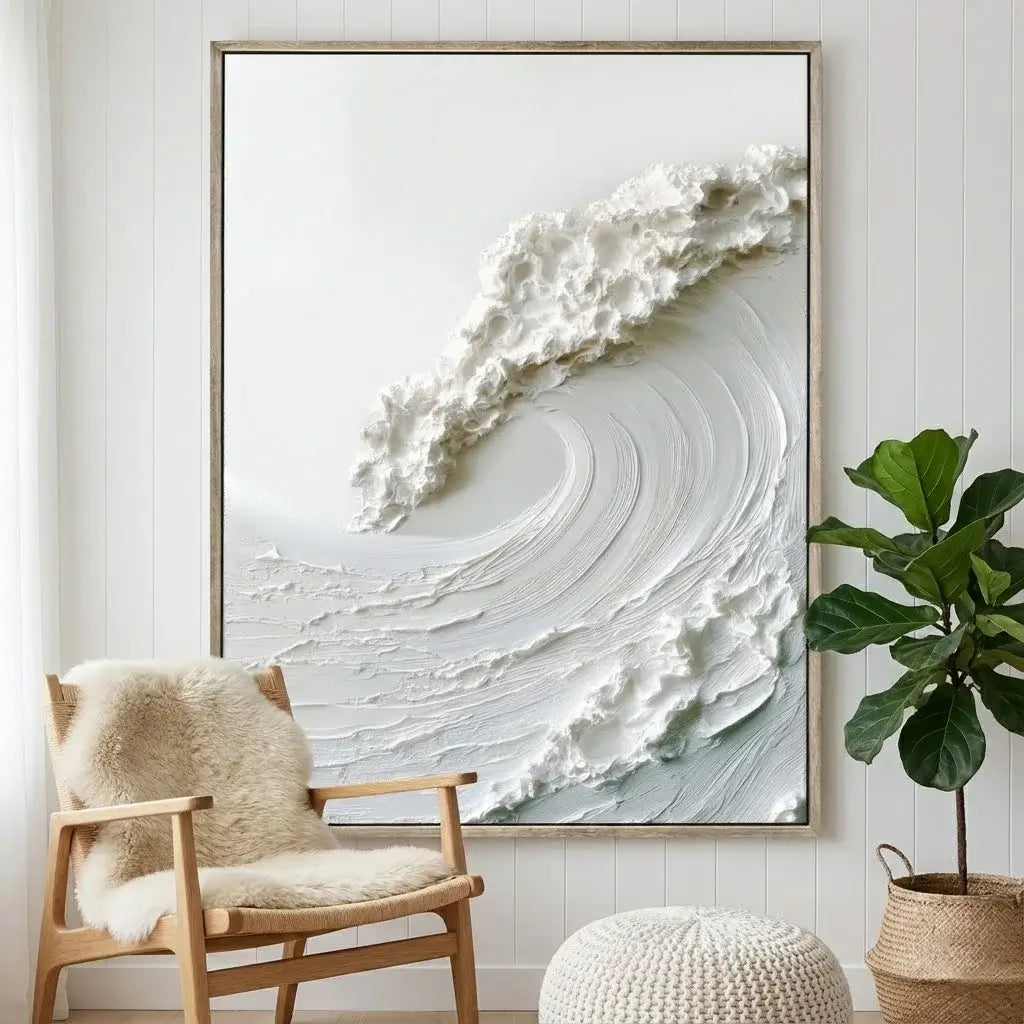 Framed abstract artwork of a wave in a room with a chair and plant.