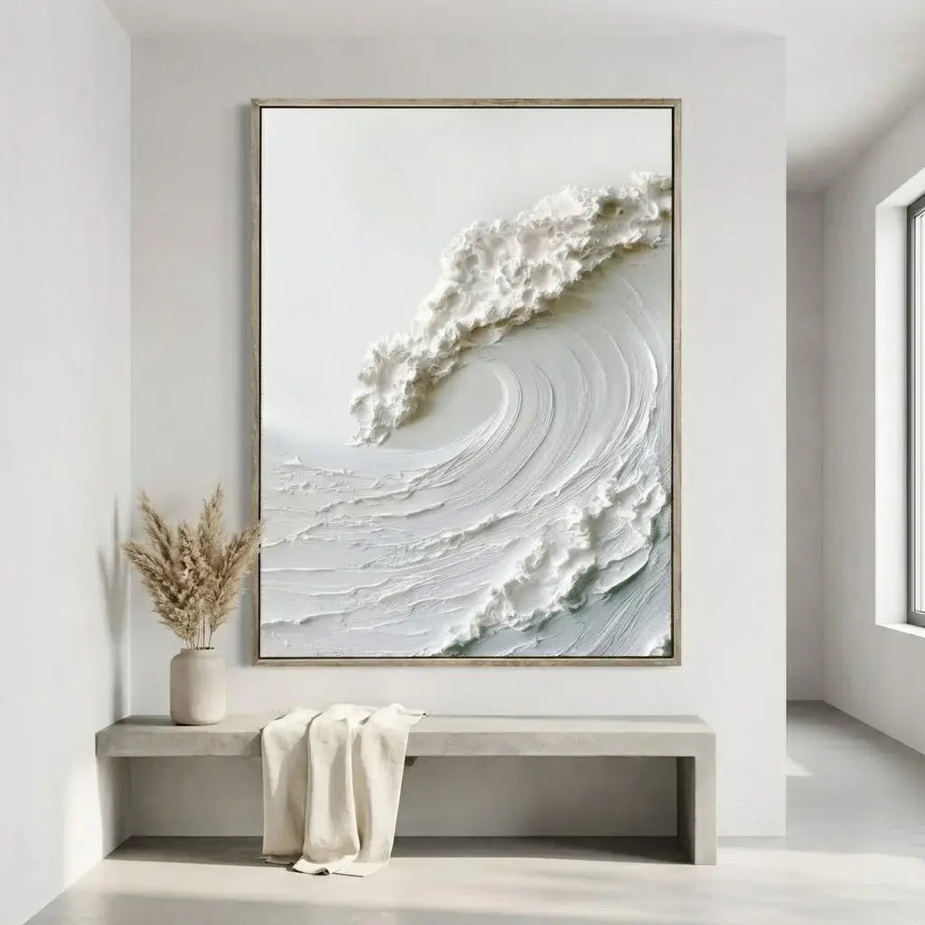 Abstract artwork of a wave in a gold frame on a white wall above a bench.