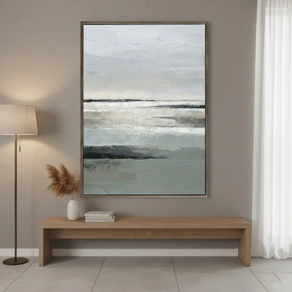 Framed abstract artwork on a wall above a wooden bench with decorative items.