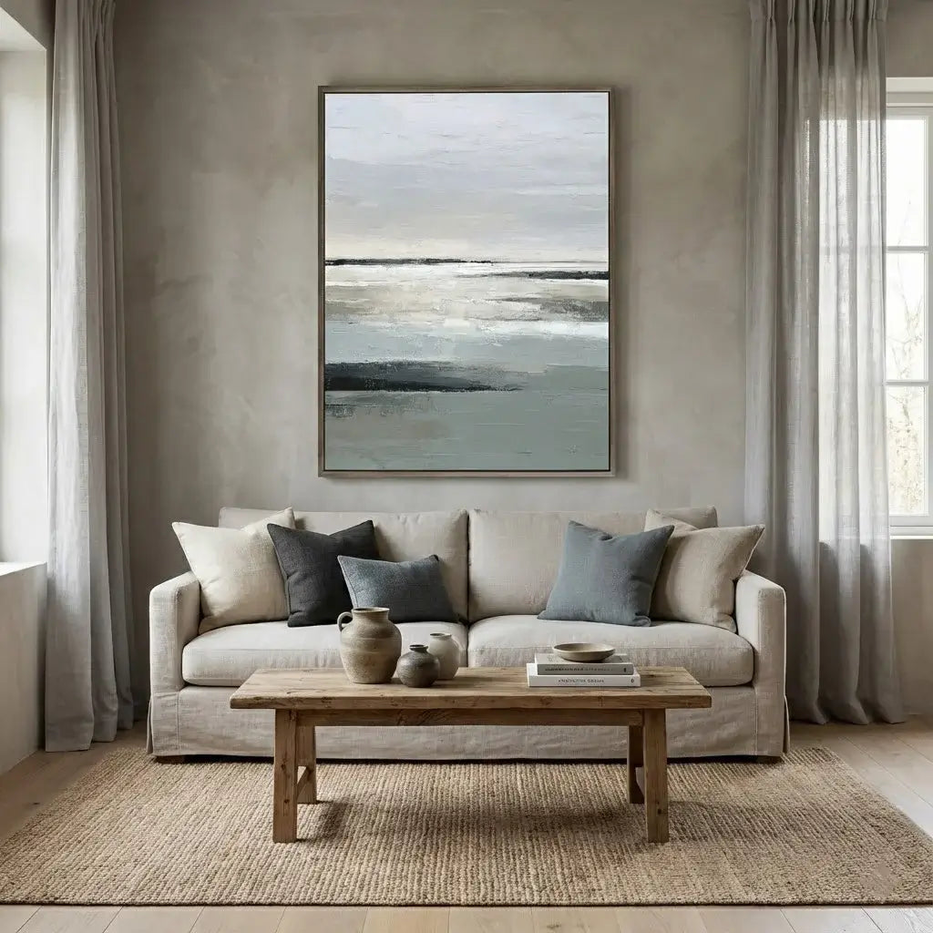 Living room with a beige sofa, wooden coffee table, and abstract painting on the wall.