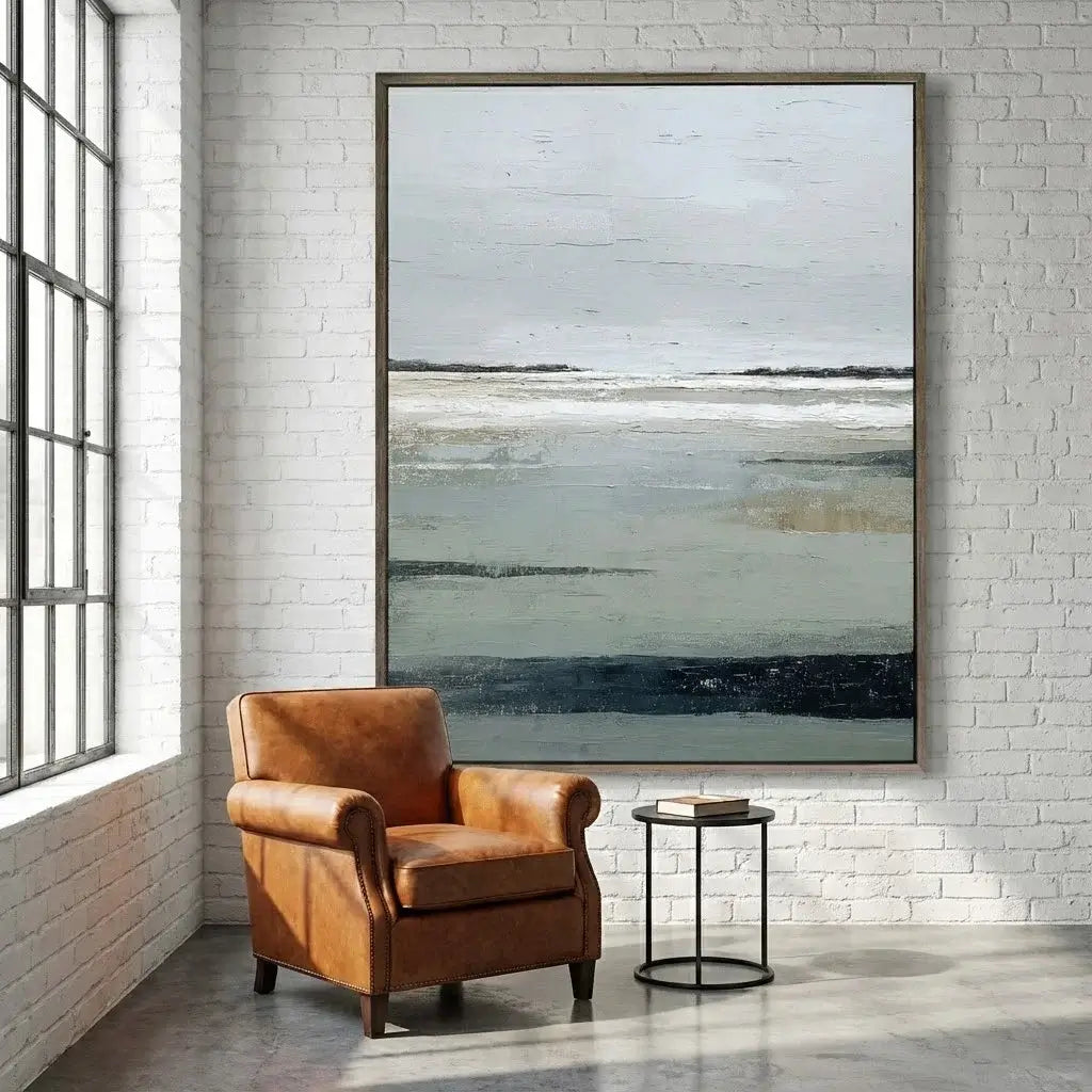 Brown leather armchair in a room with a large abstract painting on the wall.