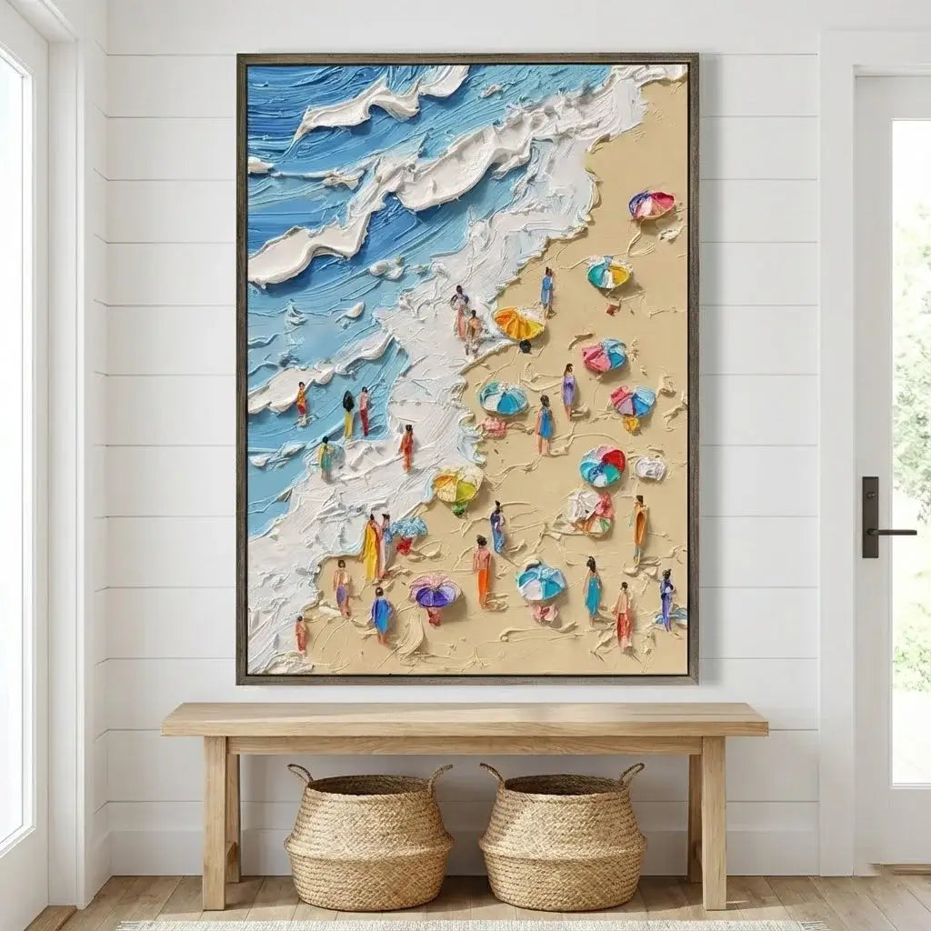 Framed artwork of a beach scene with people and umbrellas on a wall above a wooden bench.