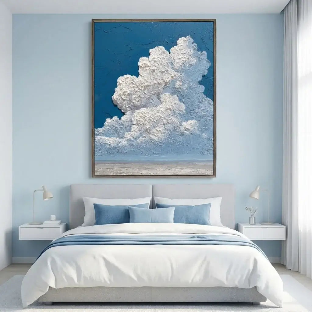 Bedroom with a large framed picture of clouds above the bed
