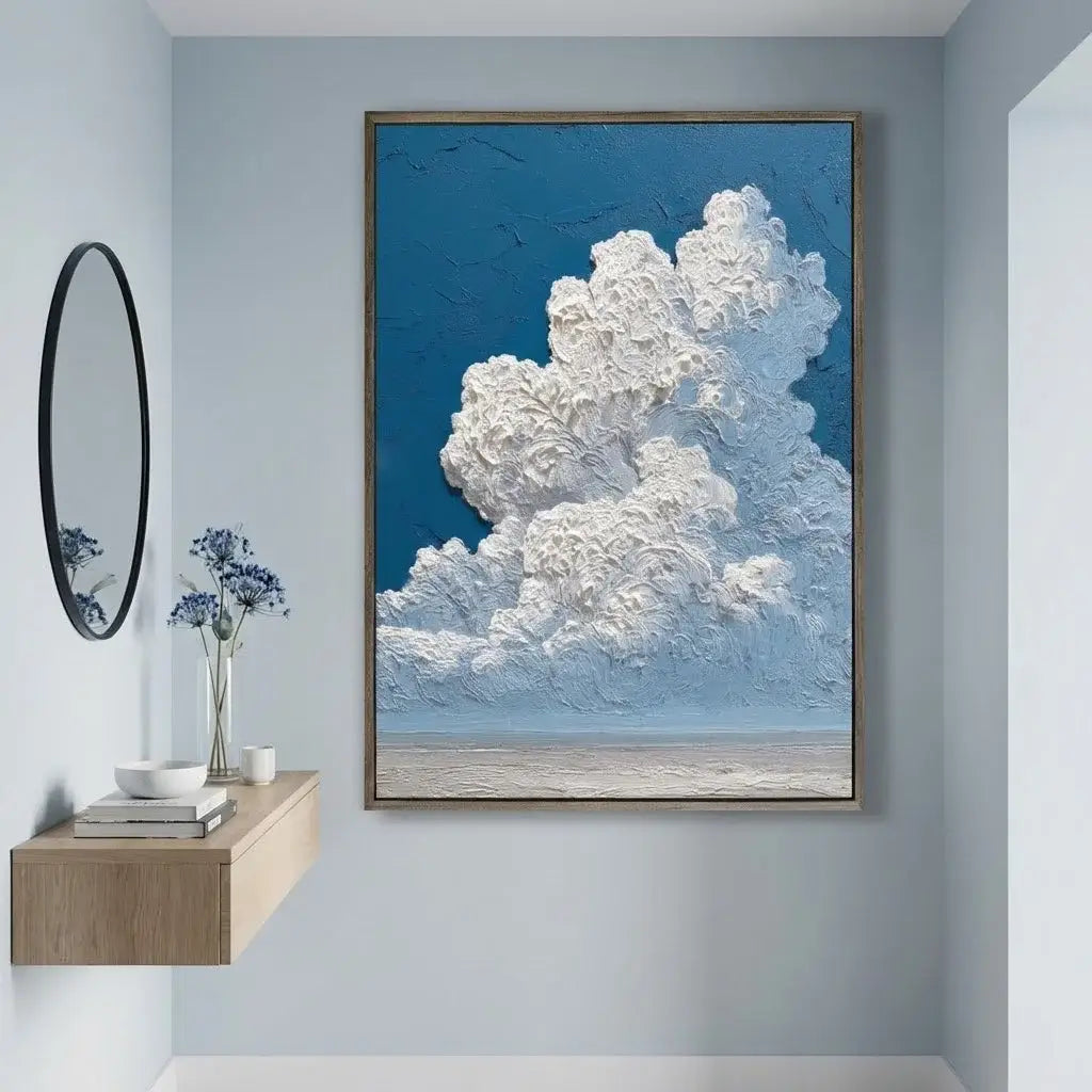 Framed artwork of a cloud on a wall in a room with a mirror and vase.