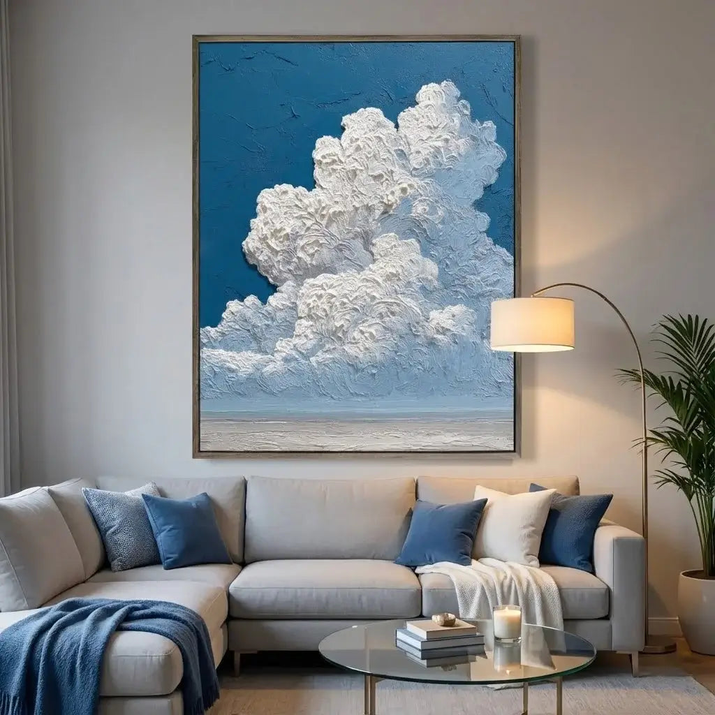 Living room with a sectional sofa, decorative pillows, a coffee table, and a large cloud art piece on the wall.