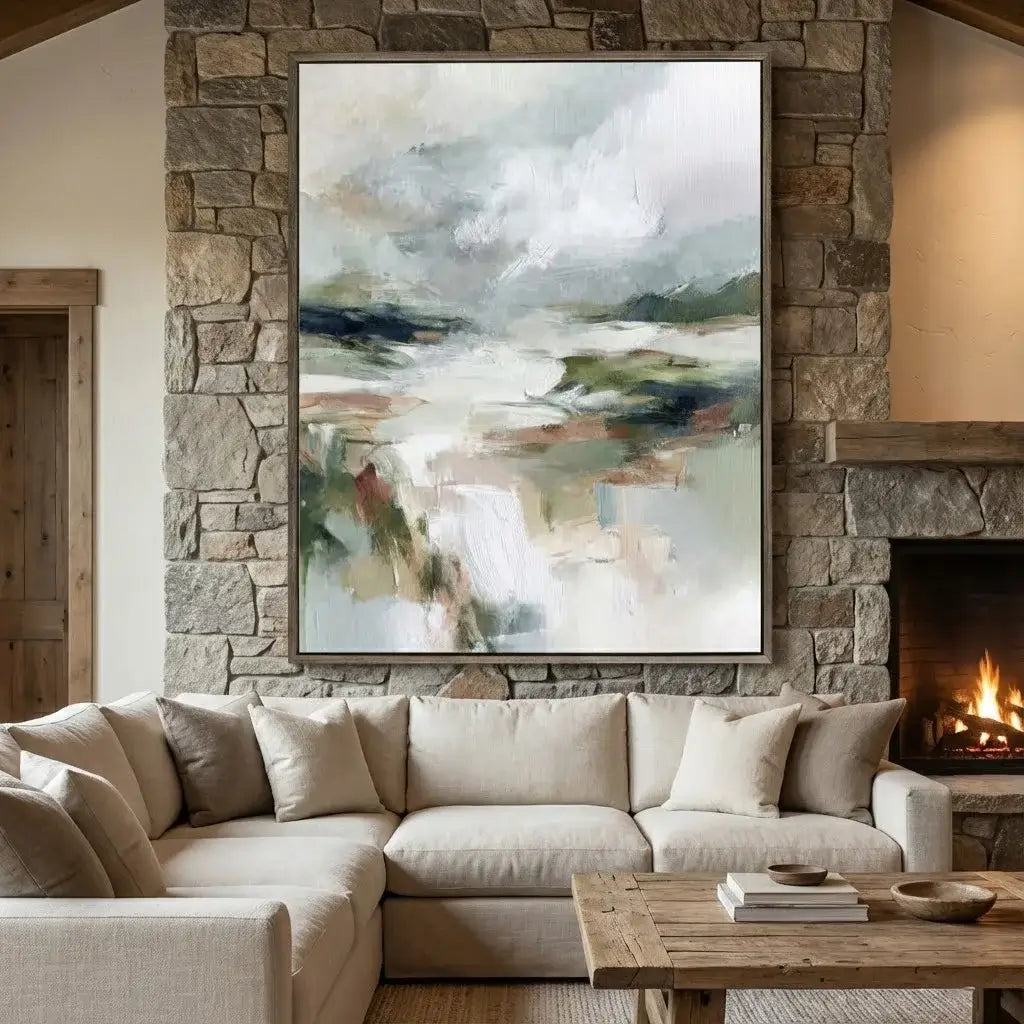 Living room with a stone wall, sectional sofa, and abstract painting above.