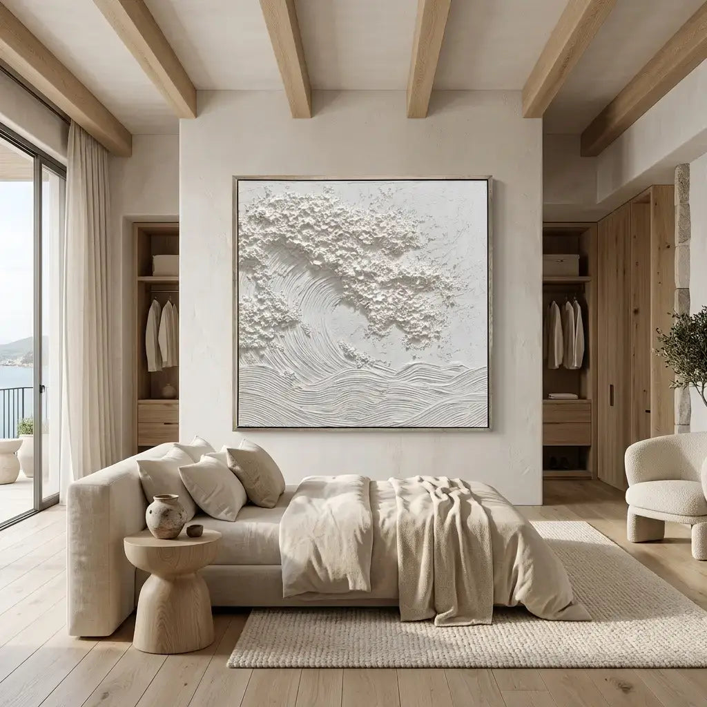 Modern bedroom with neutral tones, artwork on the wall, and a bed.