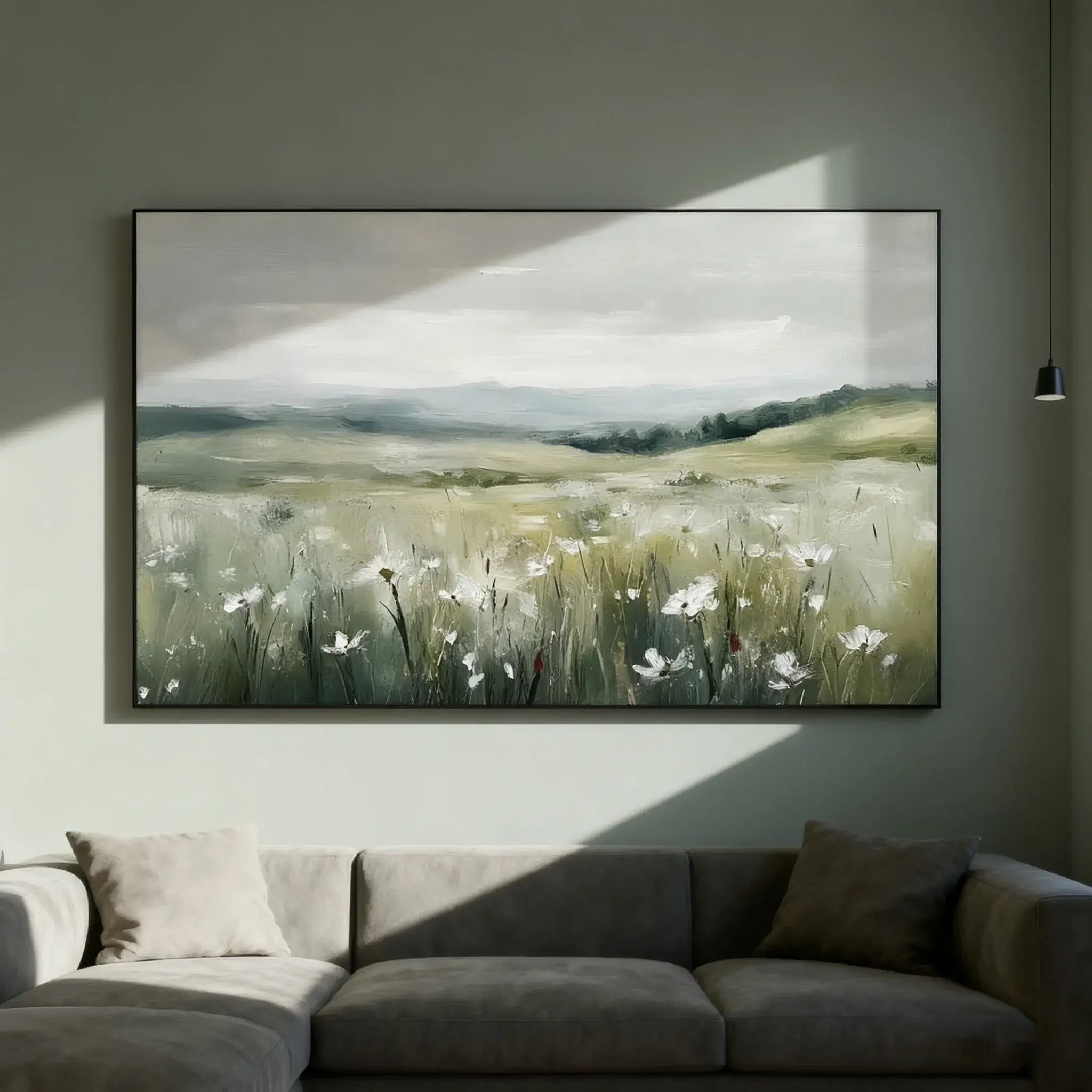Large landscape painting of a field with flowers on a wall above a sofa.