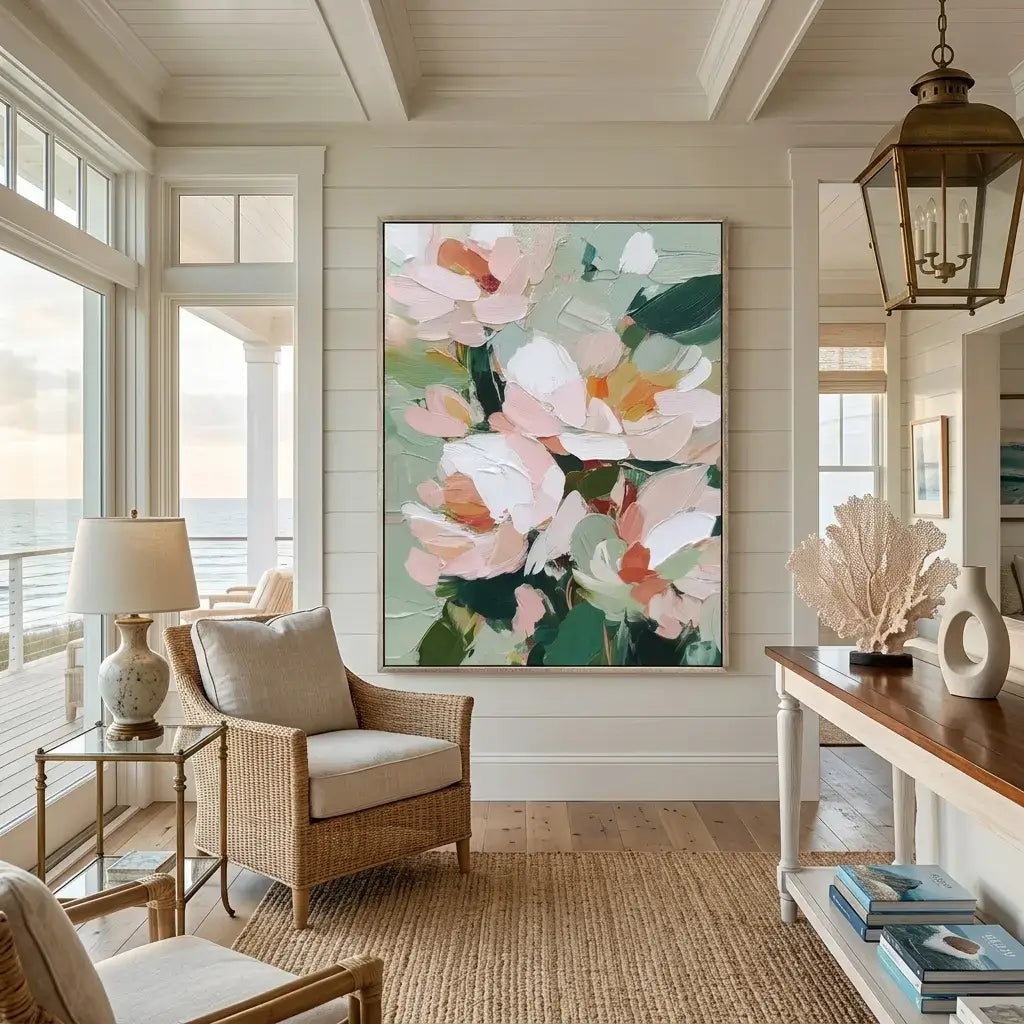 Living room with floral artwork on the wall, wicker chair, and lamp.