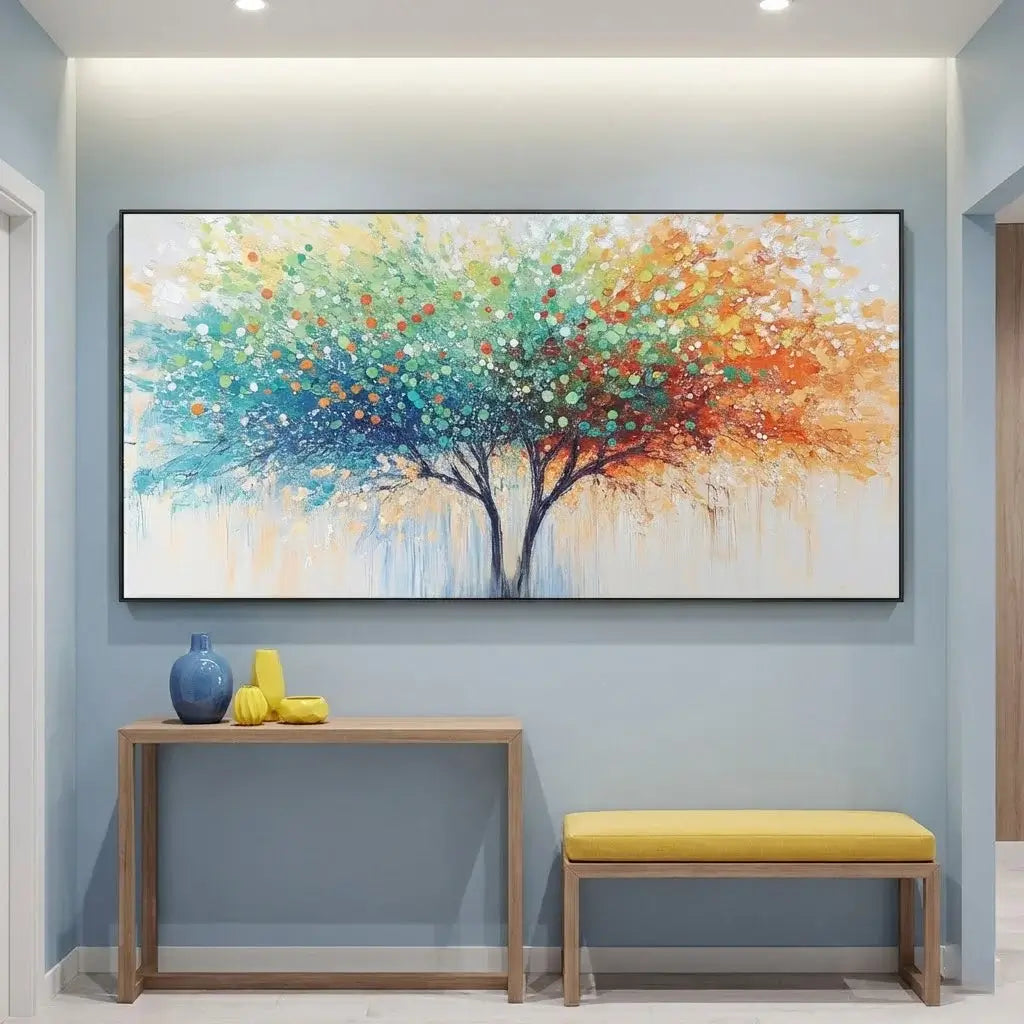 Colorful abstract tree painting on a wall with a wooden console table and yellow bench below.