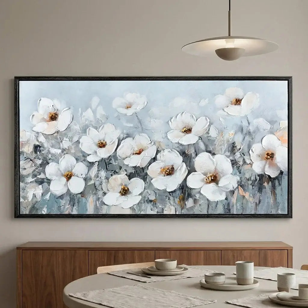 Framed abstract floral artwork on a wall above a dining table.