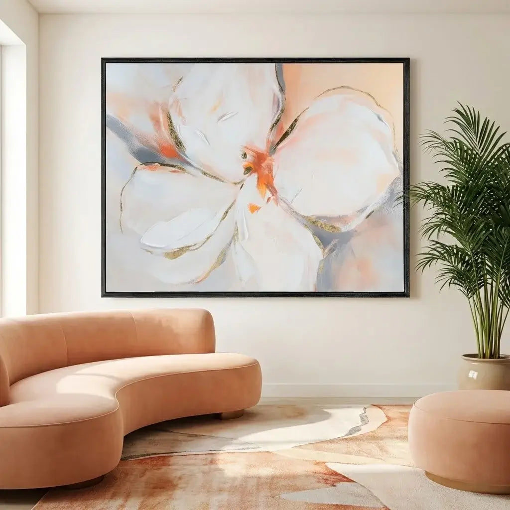 Living room with a large abstract floral painting on the wall, a curved beige sofa, and a potted plant.