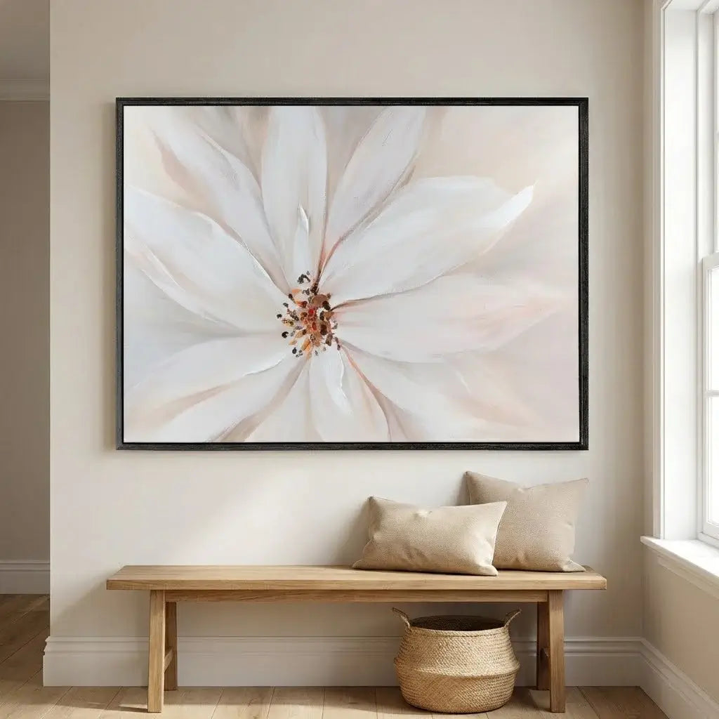 Framed floral artwork above a wooden bench in a room with natural light.